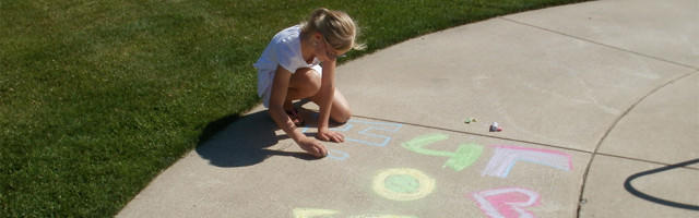 Student writing on the ground